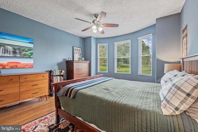 3004 E Pratt St, Baltimore, MD 21224 - bedroom featuring wood finished floors, a textured ceiling, and a ceiling fan
