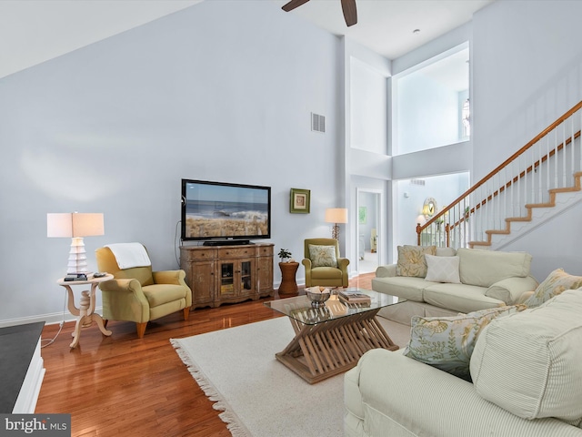 1 Lake Village Cir, Ocean View, DE 19970 - living area with a towering ceiling, wood finished floors, a ceiling fan, baseboards, and stairs