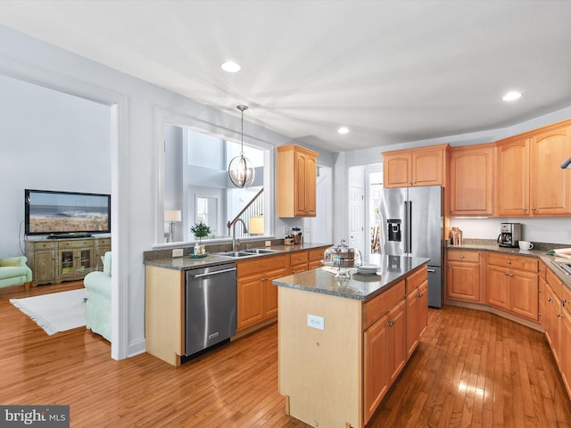 1 Lake Village Cir, Ocean View, DE 19970 - kitchen with stainless steel appliances, a sink, a kitchen island, light wood finished floors, and healthy amount of natural light