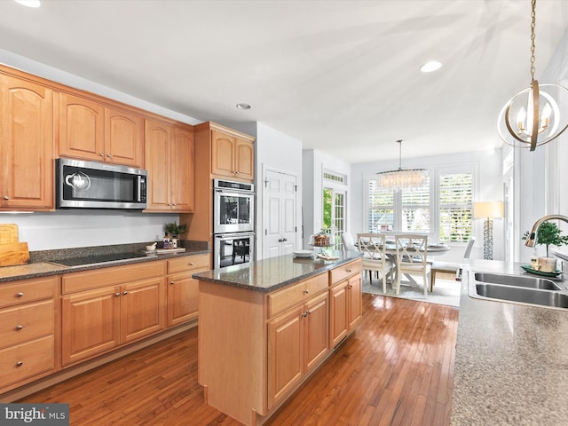 1 Lake Village Cir, Ocean View, DE 19970 - kitchen featuring stainless steel appliances, a chandelier, a sink, wood-type flooring, and decorative light fixtures
