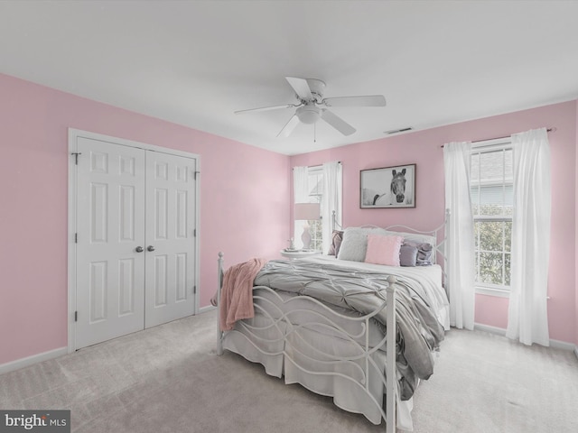 1 Lake Village Cir, Ocean View, DE 19970 - carpeted bedroom featuring multiple windows, a closet, baseboards, and ceiling fan