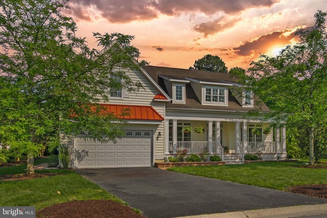 1 Lake Village Cir, Ocean View, DE 19970 - view of front of property featuring covered porch, concrete driveway, a standing seam roof, a lawn, and a garage