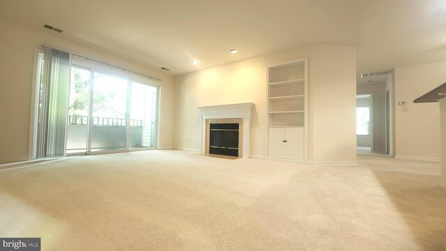 7705 Lafayette Forest Dr Unit 77, Annandale, VA 22003 - unfurnished living room featuring a fireplace with flush hearth, light carpet, built in shelves, and recessed lighting