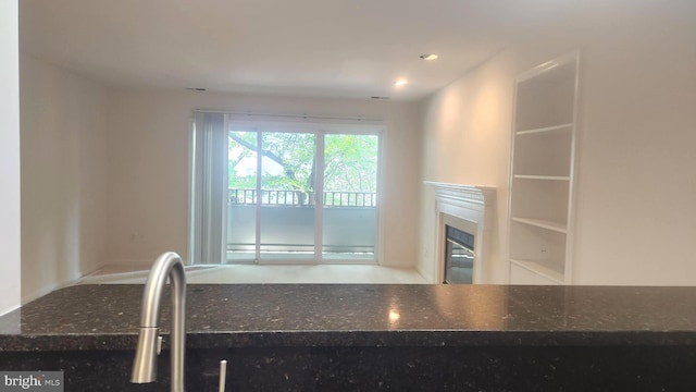 7705 Lafayette Forest Dr Unit 77, Annandale, VA 22003 - kitchen featuring a glass covered fireplace, dark stone counters, and recessed lighting