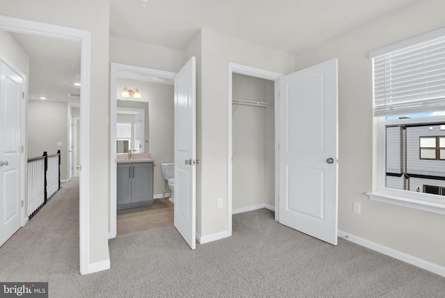 338 Ensemble Way, Frederick, MD 21701 - unfurnished bedroom with carpet, baseboards, connected bathroom, a closet, and multiple windows