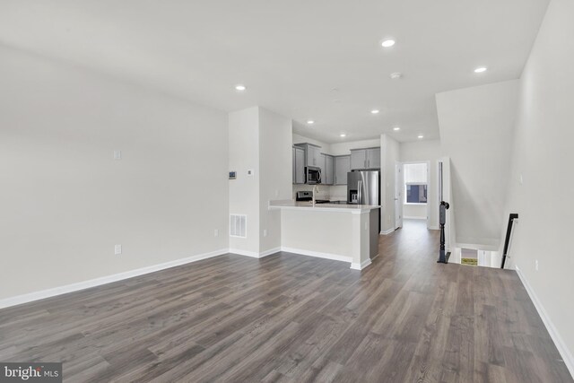 338 Ensemble Way, Frederick, MD 21701 - unfurnished living room with dark wood-style floors, recessed lighting, and baseboards