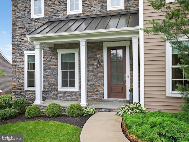 548 E Delp Rd, Lancaster, PA 17601 - view of exterior entry featuring a standing seam roof, a porch, stone siding, and a metal roof