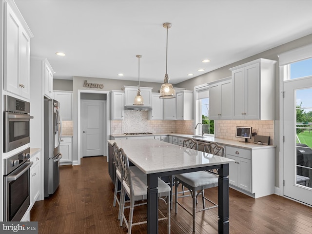 548 E Delp Rd, Lancaster, PA 17601 - kitchen featuring appliances with stainless steel finishes, a center island, dark wood finished floors, backsplash, and recessed lighting