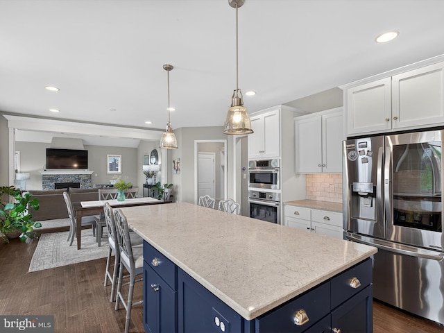 548 E Delp Rd, Lancaster, PA 17601 - kitchen with stainless steel appliances, blue cabinetry, backsplash, white cabinetry, and a center island