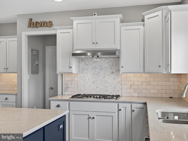 548 E Delp Rd, Lancaster, PA 17601 - kitchen featuring stainless steel gas stovetop, white cabinets, backsplash, and under cabinet range hood