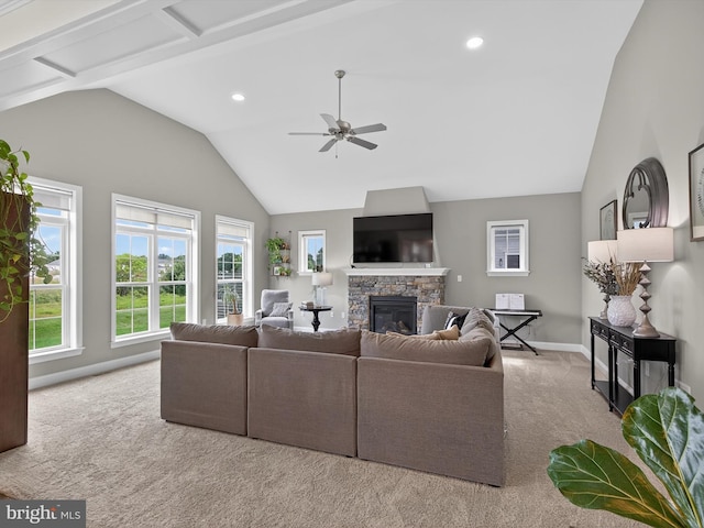548 E Delp Rd, Lancaster, PA 17601 - living area with lofted ceiling, carpet floors, a stone fireplace, plenty of natural light, and a ceiling fan