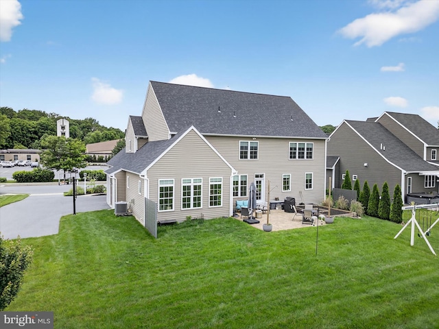 548 E Delp Rd, Lancaster, PA 17601 - rear view of house featuring a patio, a lawn, and a shingled roof