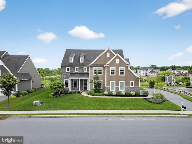 548 E Delp Rd, Lancaster, PA 17601 - view of front facade with stone siding, a front yard, and board and batten siding
