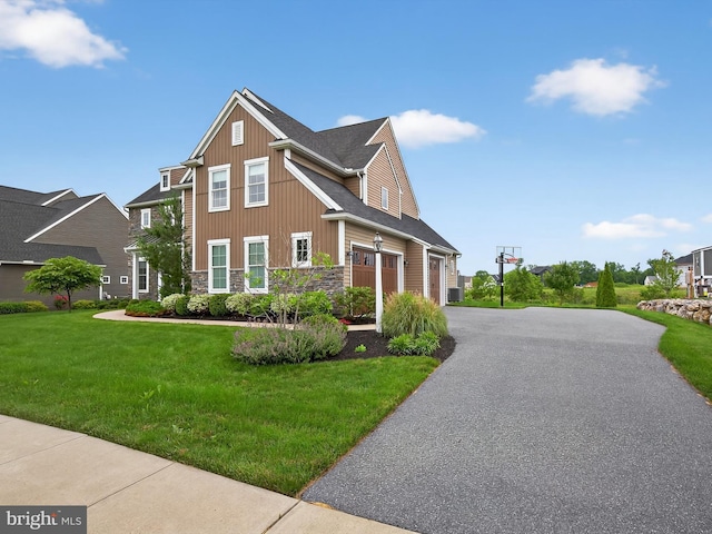 548 E Delp Rd, Lancaster, PA 17601 - view of front of home with stone siding, driveway, a front lawn, and a shingled roof