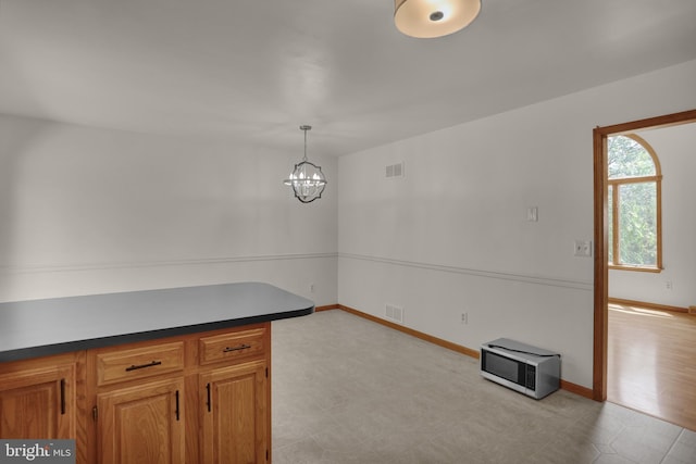 129 Deck Rd, Womelsdorf, PA 19567 - kitchen featuring a chandelier, dark countertops, and brown cabinets