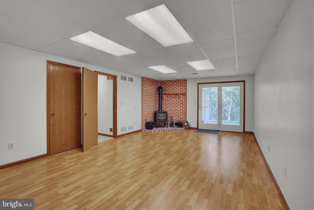 129 Deck Rd, Womelsdorf, PA 19567 - unfurnished living room featuring a wood stove, a drop ceiling, and light wood-style floors