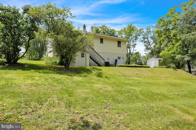 129 Deck Rd, Womelsdorf, PA 19567 - view of green lawn featuring a shed, stairway, and an attached garage