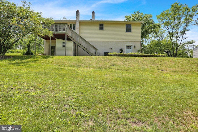 129 Deck Rd, Womelsdorf, PA 19567 - back of property featuring stairs, a yard, a wooden deck, and a chimney