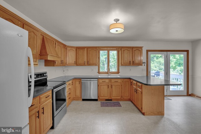 129 Deck Rd, Womelsdorf, PA 19567 - kitchen with stainless steel appliances, a peninsula, healthy amount of natural light, and custom range hood
