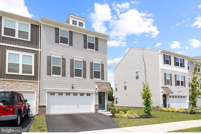 8790 Kensington Church St, Manassas, VA 20112 - view of property with asphalt driveway, an attached garage, and board and batten siding