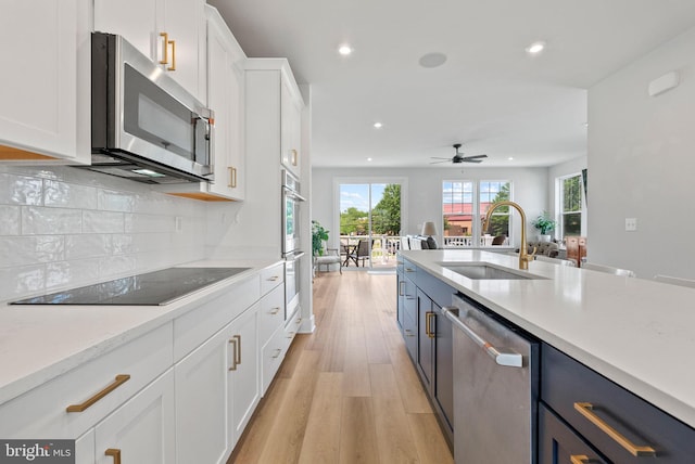 8790 Kensington Church St, Manassas, VA 20112 - kitchen featuring appliances with stainless steel finishes, a sink, recessed lighting, white cabinetry, and light countertops
