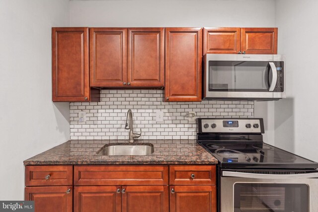 2126 N Palethorp St, Philadelphia, PA 19122 - kitchen with stainless steel appliances, a sink, tasteful backsplash, and dark stone countertops