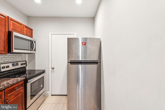 2126 N Palethorp St, Philadelphia, PA 19122 - kitchen featuring appliances with stainless steel finishes, recessed lighting, tasteful backsplash, light tile patterned floors, and dark stone countertops