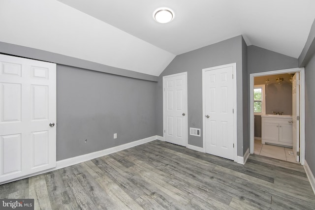 133 E Federal St, Burlington, NJ 08016 - unfurnished bedroom featuring lofted ceiling, wood finished floors, baseboards, and a sink