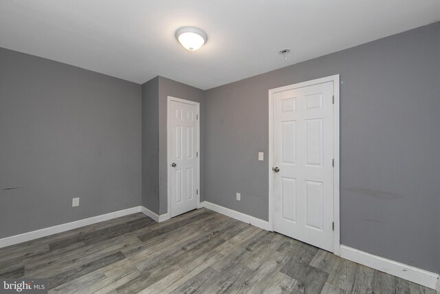 133 E Federal St, Burlington, NJ 08016 - unfurnished bedroom with wood finished floors, baseboards, and a closet