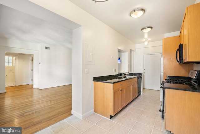 3901 Connecticut Ave NW Unit 406, Washington, DC 20008 - kitchen featuring gas stove, black microwave, dishwasher, baseboards, and light tile patterned floors