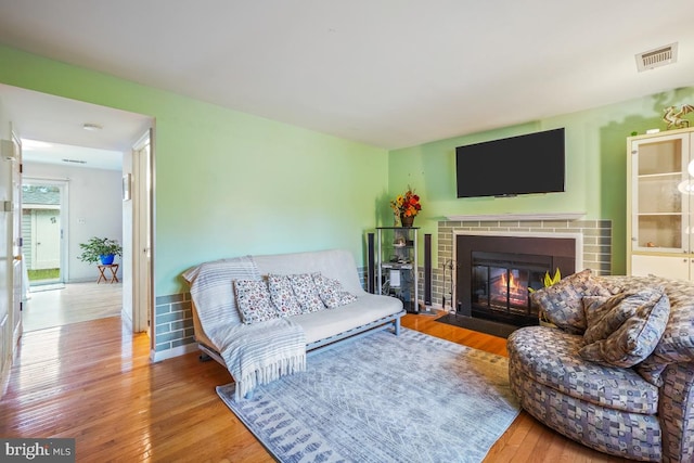 7719 Haines Ct, Laurel, MD 20707 - living area with wood-type flooring and a brick fireplace
