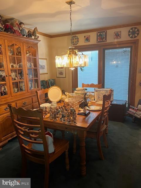 46 Carriage Stop Pl, Florence, NJ 08518 - dining area with a chandelier, crown molding, and dark carpet