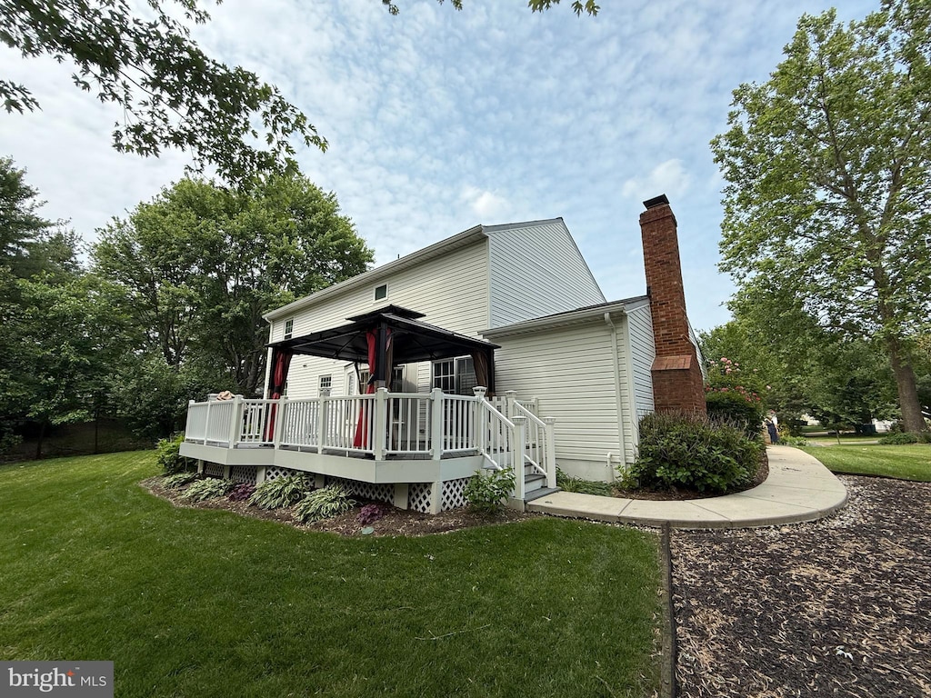 2240 Halter Ln, Reston, VA 20191 - rear view of property featuring a gazebo, a chimney, a deck, and a lawn