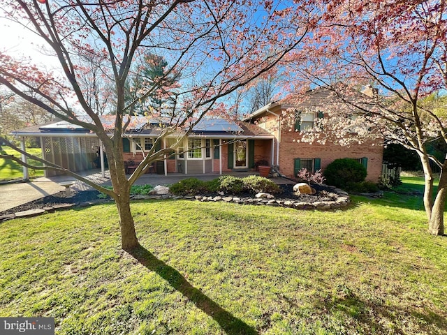 201 Mowbray Rd, Silver Spring, MD 20904 - tri-level home with brick siding, solar panels, a front lawn, and a carport