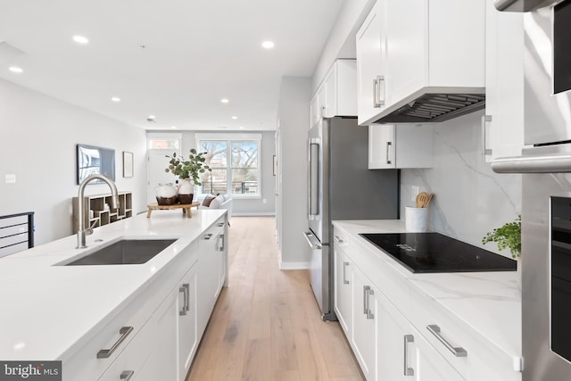 414 D St SE Unit A, Washington, DC 20003 - kitchen featuring black electric stovetop, a sink, light wood-style floors, recessed lighting, and white cabinets