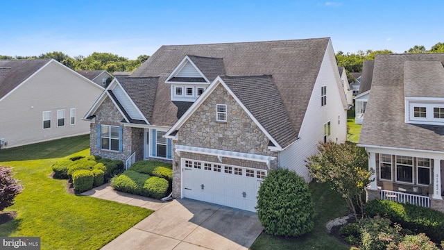 31746 Chablis Ln Unit 71, Lewes, DE 19958 - craftsman house with stone siding, driveway, a front lawn, an attached garage, and a shingled roof