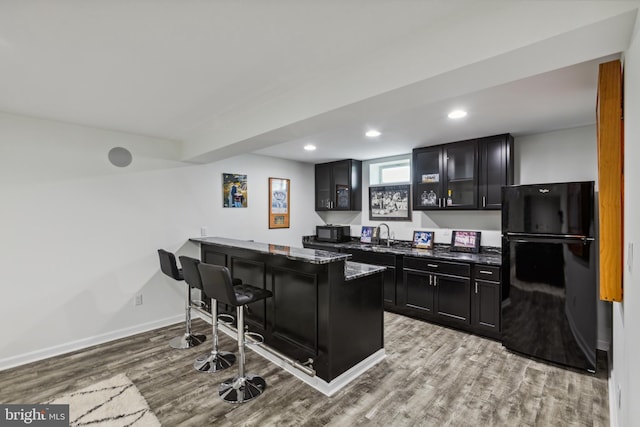 31746 Chablis Ln Unit 71, Lewes, DE 19958 - bar with black appliances, wood finished floors, baseboards, recessed lighting, and a sink