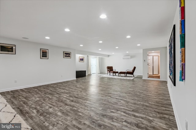 31746 Chablis Ln Unit 71, Lewes, DE 19958 - unfurnished living room featuring dark wood-style floors, recessed lighting, a wall mounted air conditioner, and baseboards