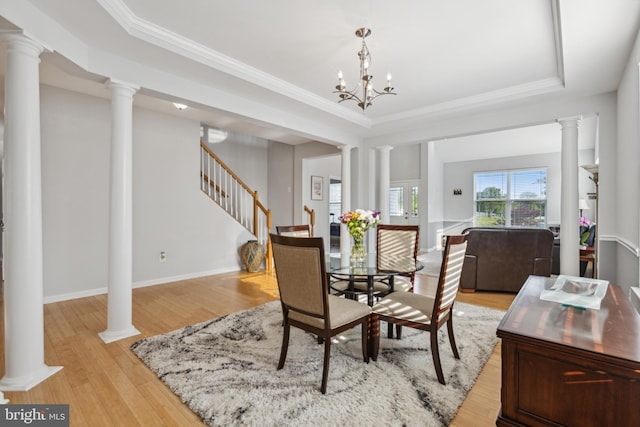31746 Chablis Ln Unit 71, Lewes, DE 19958 - dining space with stairs, light wood-style flooring, a raised ceiling, ornamental molding, and decorative columns