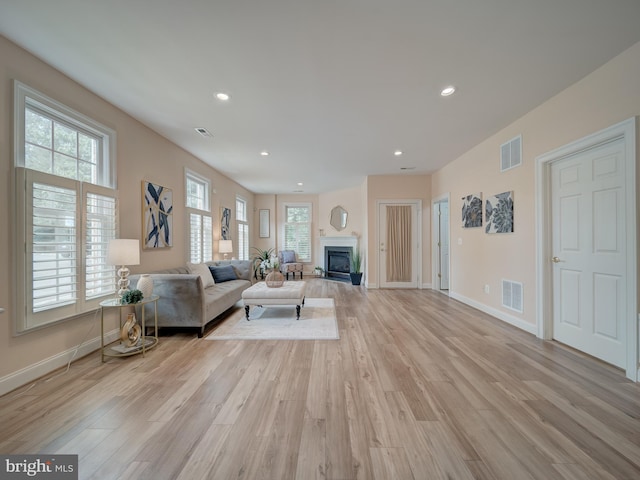8320 Dockray Ct, Lorton, VA 22079 - living area featuring light wood finished floors, recessed lighting, and a glass covered fireplace