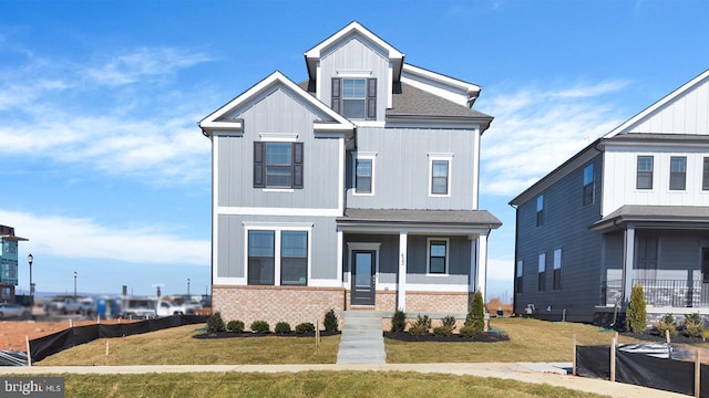 470 Herringbone Way, Frederick, MD 21701 - view of front facade with board and batten siding, brick siding, a front lawn, and a porch