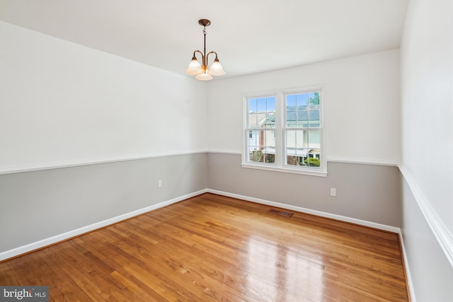 9523 Greencastle Ln, Lorton, VA 22079 - empty room with a chandelier, baseboards, and wood finished floors