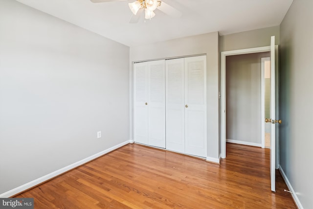 9523 Greencastle Ln, Lorton, VA 22079 - unfurnished bedroom with light wood-type flooring, a closet, baseboards, and a ceiling fan