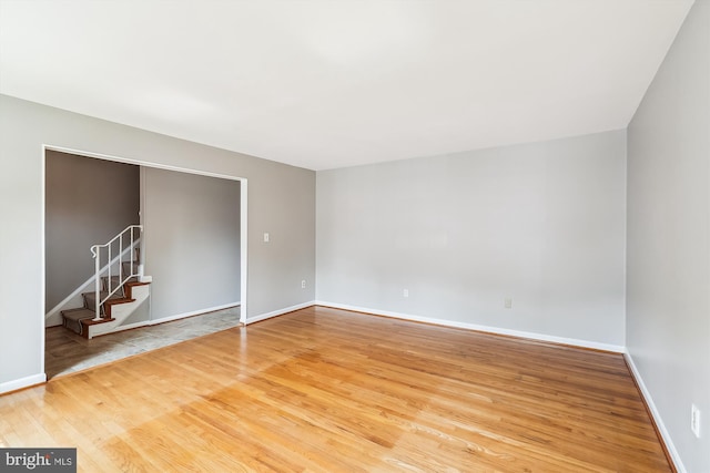 9523 Greencastle Ln, Lorton, VA 22079 - unfurnished room with wood finished floors, baseboards, and stairway