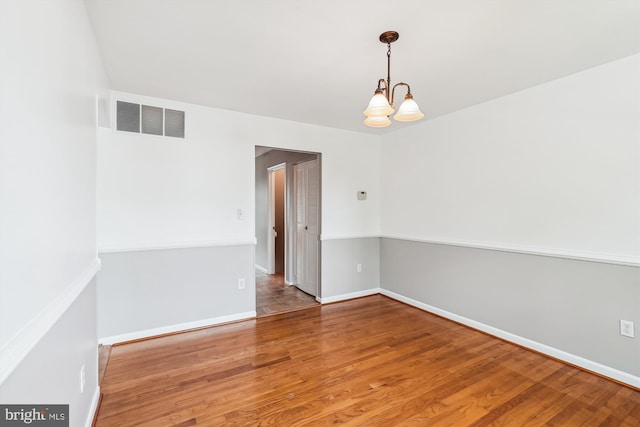 9523 Greencastle Ln, Lorton, VA 22079 - spare room with wood finished floors, a chandelier, and baseboards