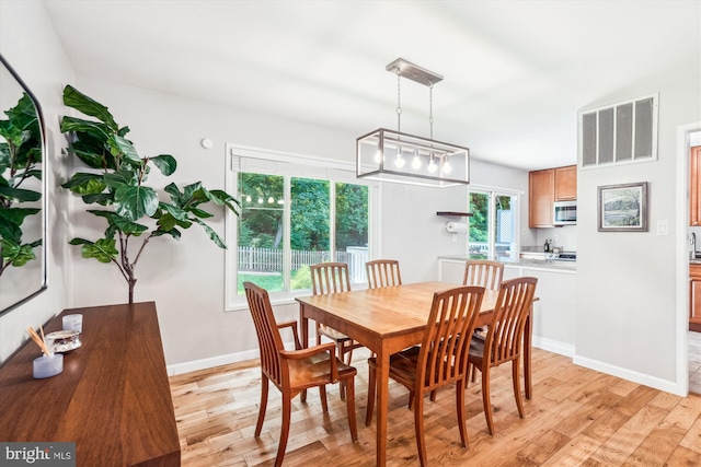 10105 Meredith Ave, Silver Spring, MD 20910 - dining room featuring light wood-style floors, baseboards, and a chandelier