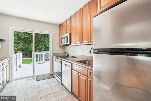 10105 Meredith Ave, Silver Spring, MD 20910 - kitchen with appliances with stainless steel finishes, a sink, brown cabinets, and light tile patterned floors