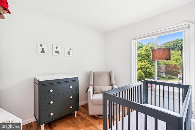 10105 Meredith Ave, Silver Spring, MD 20910 - bedroom featuring wood finished floors, a crib, and baseboards