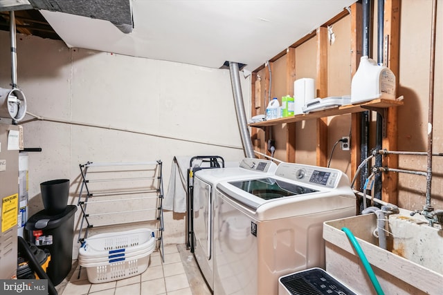 10105 Meredith Ave, Silver Spring, MD 20910 - laundry room with washing machine and dryer, light tile patterned flooring, and a sink