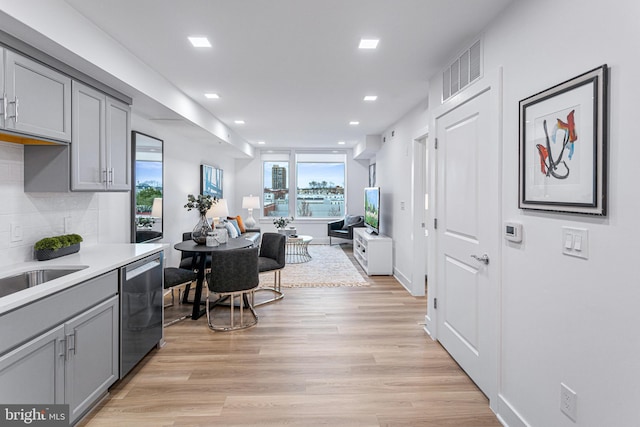 701 N Henry St Unit 212, Alexandria, VA 22314 - kitchen with gray cabinetry, stainless steel dishwasher, recessed lighting, tasteful backsplash, and light countertops